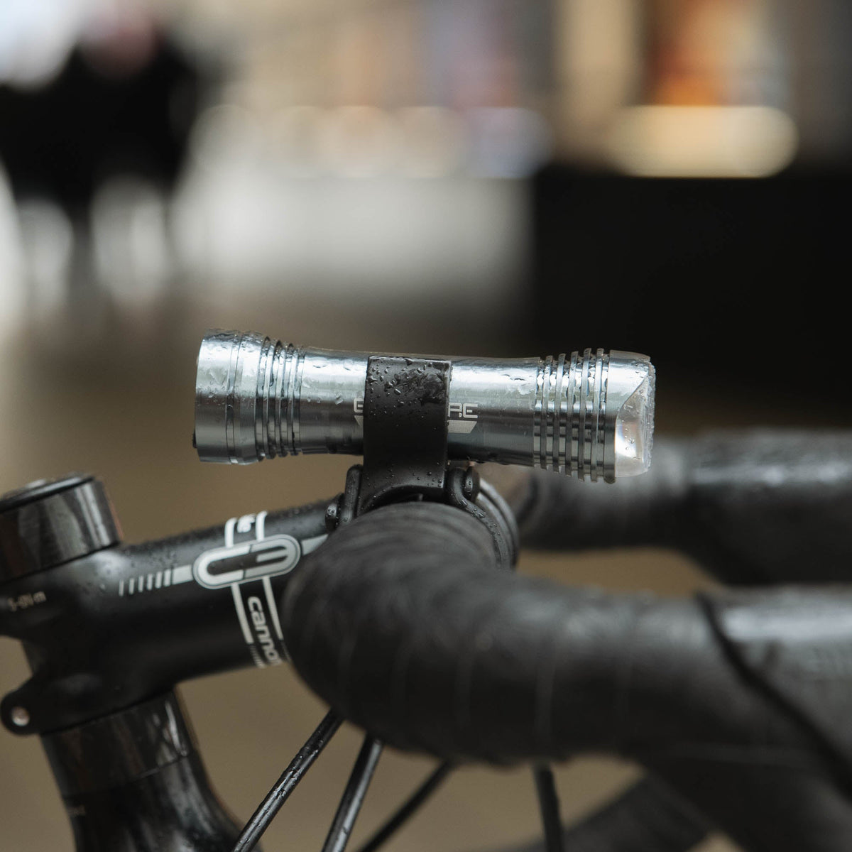 Exposure Lights Sirius 11 rechargeable front bicycle light with gunmetal grey CNC-machined aluminium body, 1300-lumen output and USB-C charging.