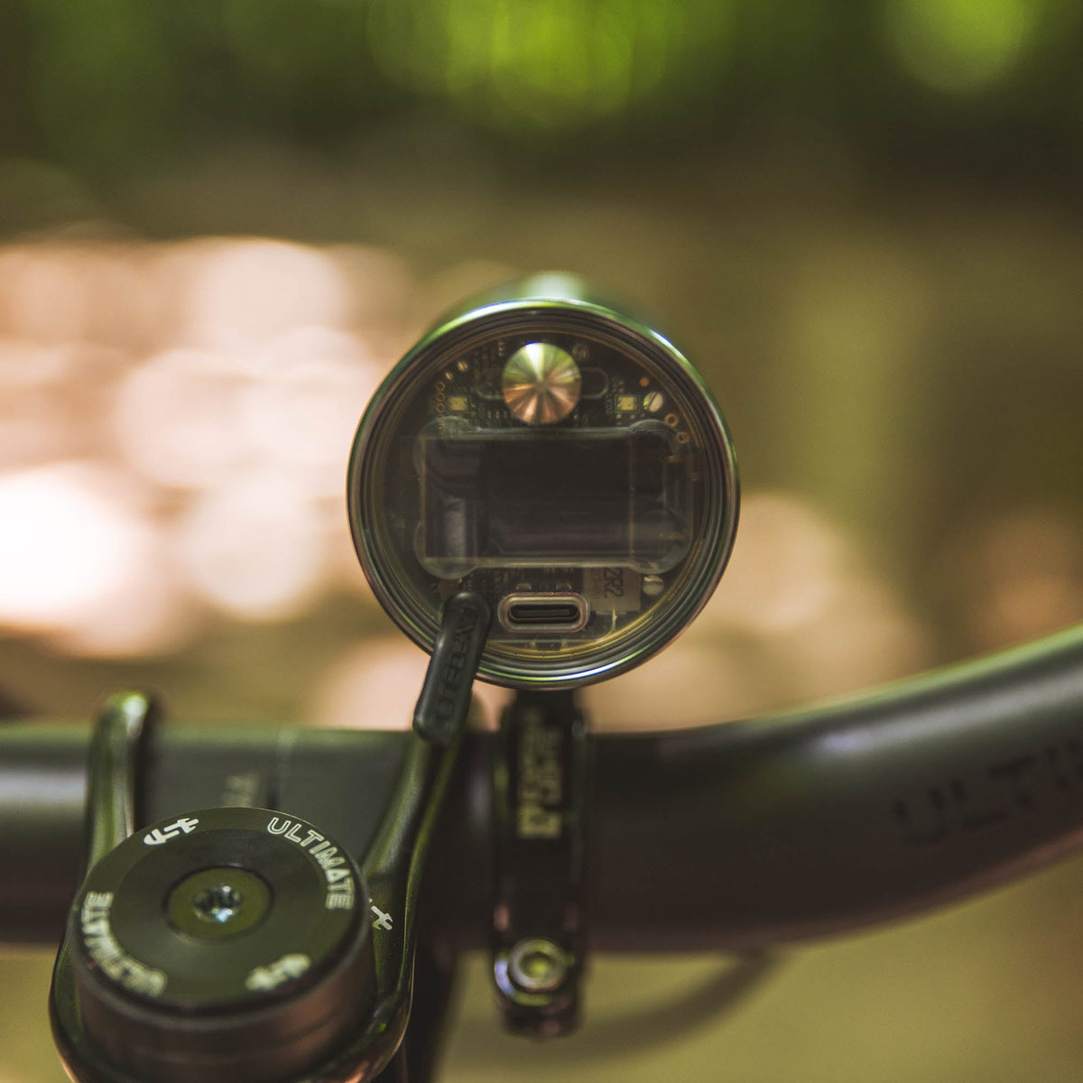 Exposure Lights Toro 16 rechargeable front bicycle light with gunmetal grey CNC-machined aluminium body, 3850-lumen output, colour OLED display and REFLEX 2.0 technology.