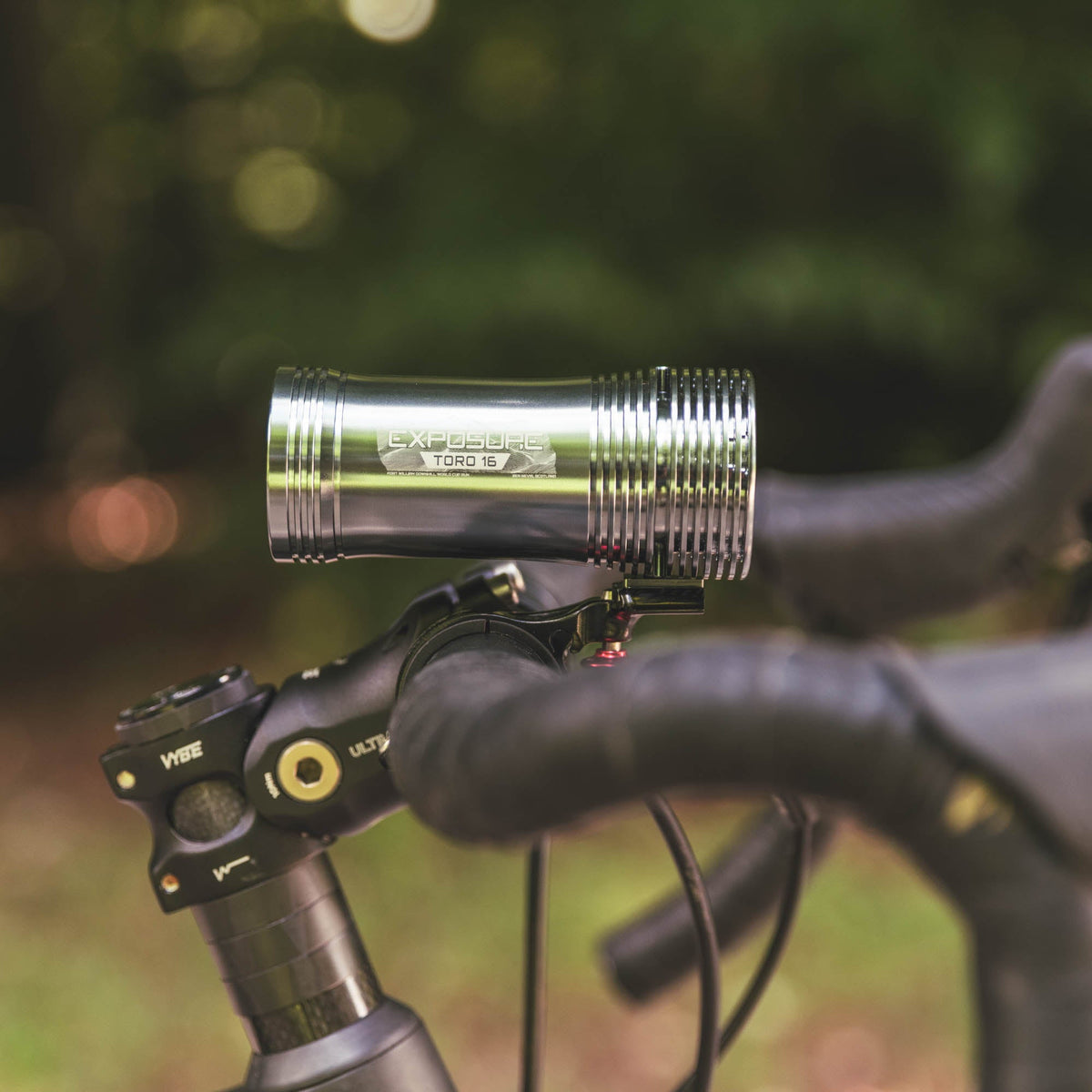 Exposure Lights Toro 16 rechargeable front bicycle light with gunmetal grey CNC-machined aluminium body, 3850-lumen output, colour OLED display and REFLEX 2.0 technology.