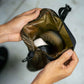 Person holding a coyote brown Fairweather Dry Sack , containing a pair of shoes.