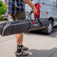 Feedback Sports Pro Ultralight bike repair stand packed inside the porter bag and being carried by a human 