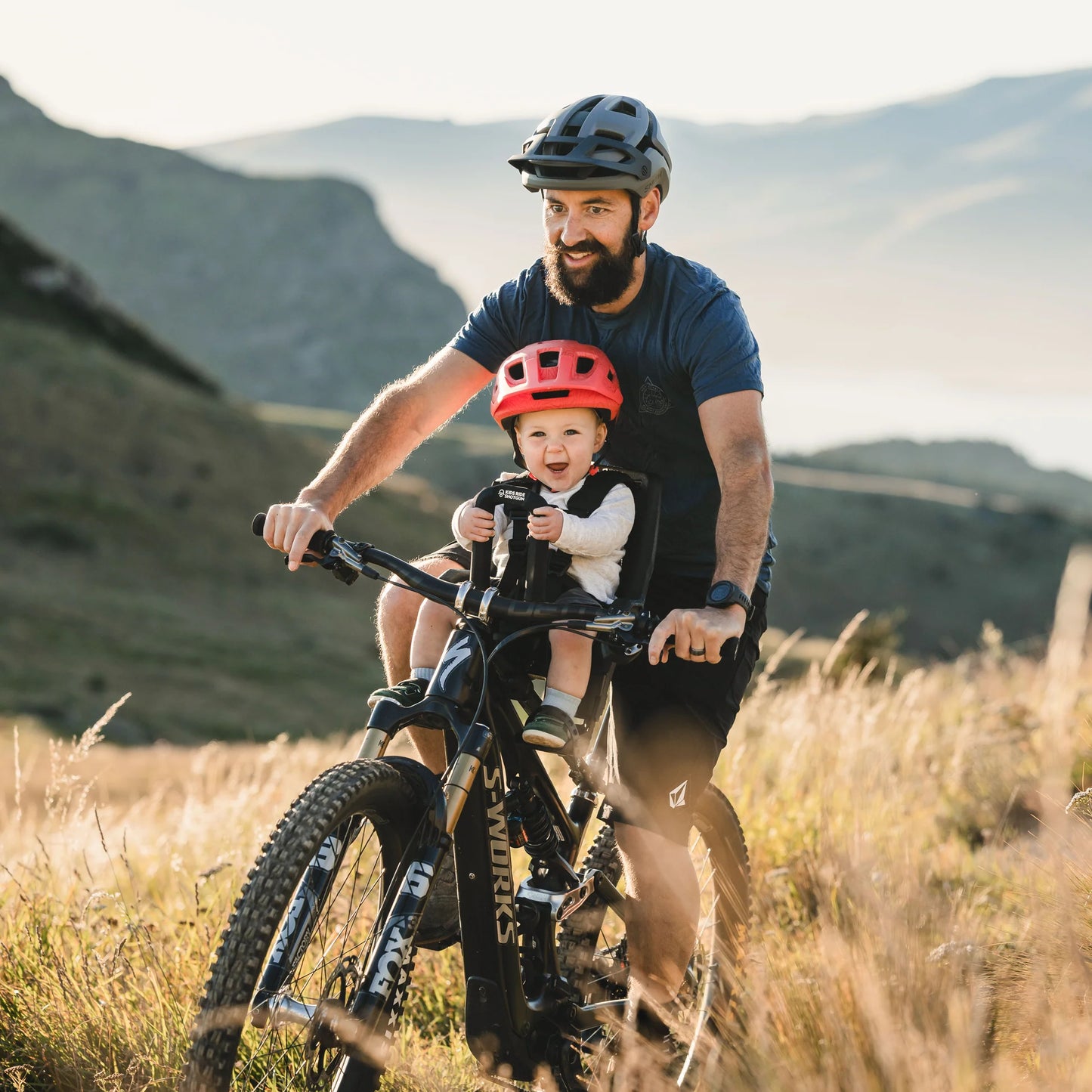 Kids Ride Shotgun Pro EVO child bike seat installed on a MTB front view with adult rider and a child using it