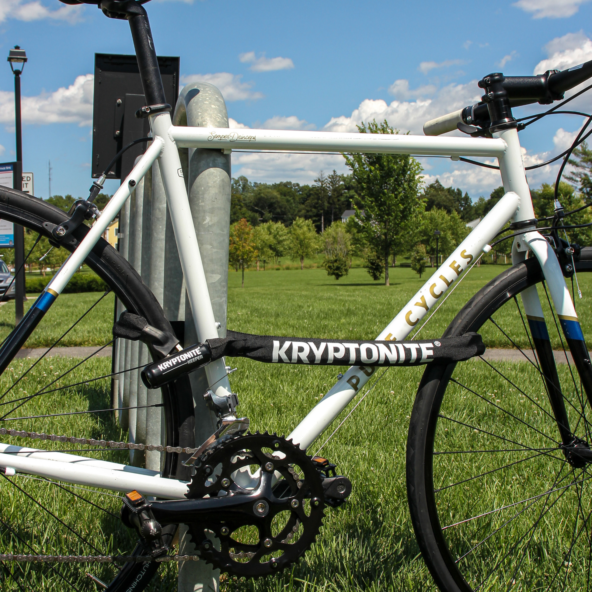 Kryptonite Keeper 712 integrated chain lock coiled with nylon sleeve locking bike to bike rack