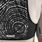 Close-up of a cycling hydration vest with digital pattern and 'PEDALED' branding.