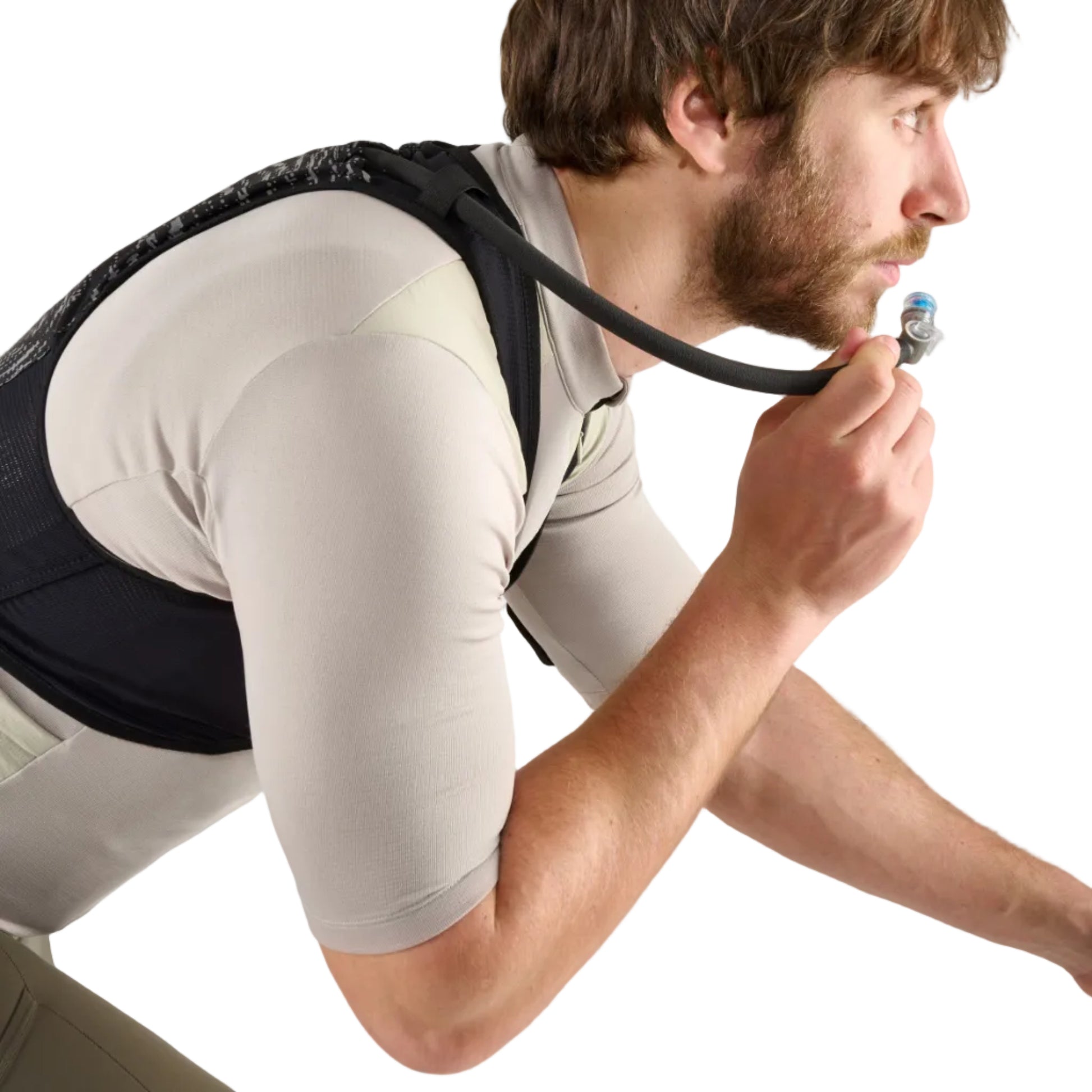 Man wearing a black backpack and beige shorts on a white background