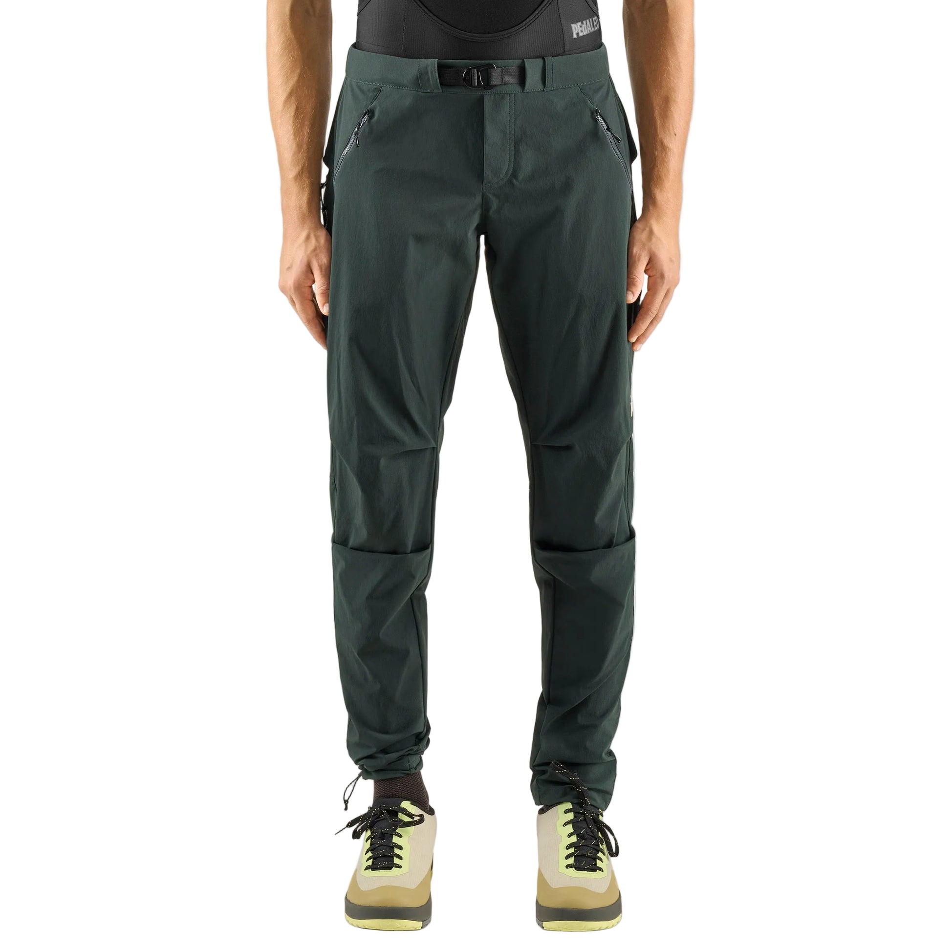 Man wearing Pedaled Yuma trail pants in dark green for trail riding and bikepacking and adventure cycling