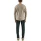 Man wearing a pedaled beige long-sleeve tech jersey shirt and Yuma Trail Pants dark pants on a light gray background
