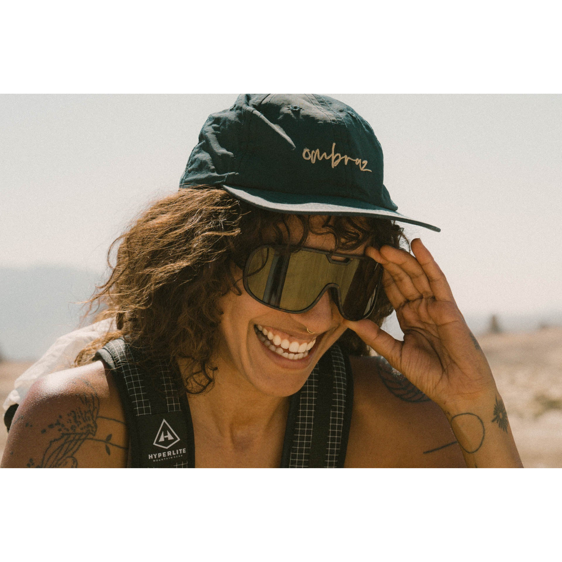 Person wearing Ombraz Refugio armless sunglasses 
