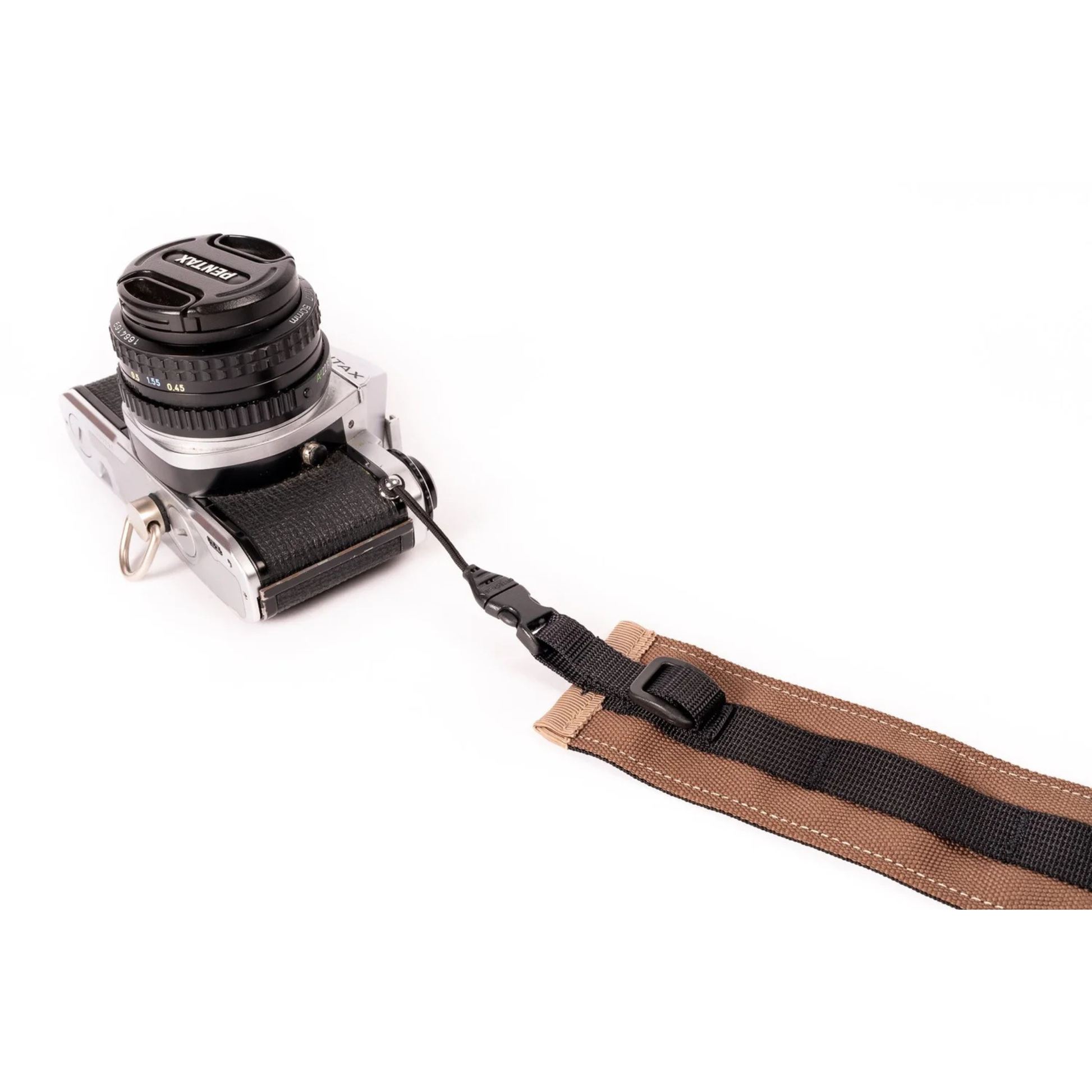 Outer Shell camera strap brown with one end attached to a camera 