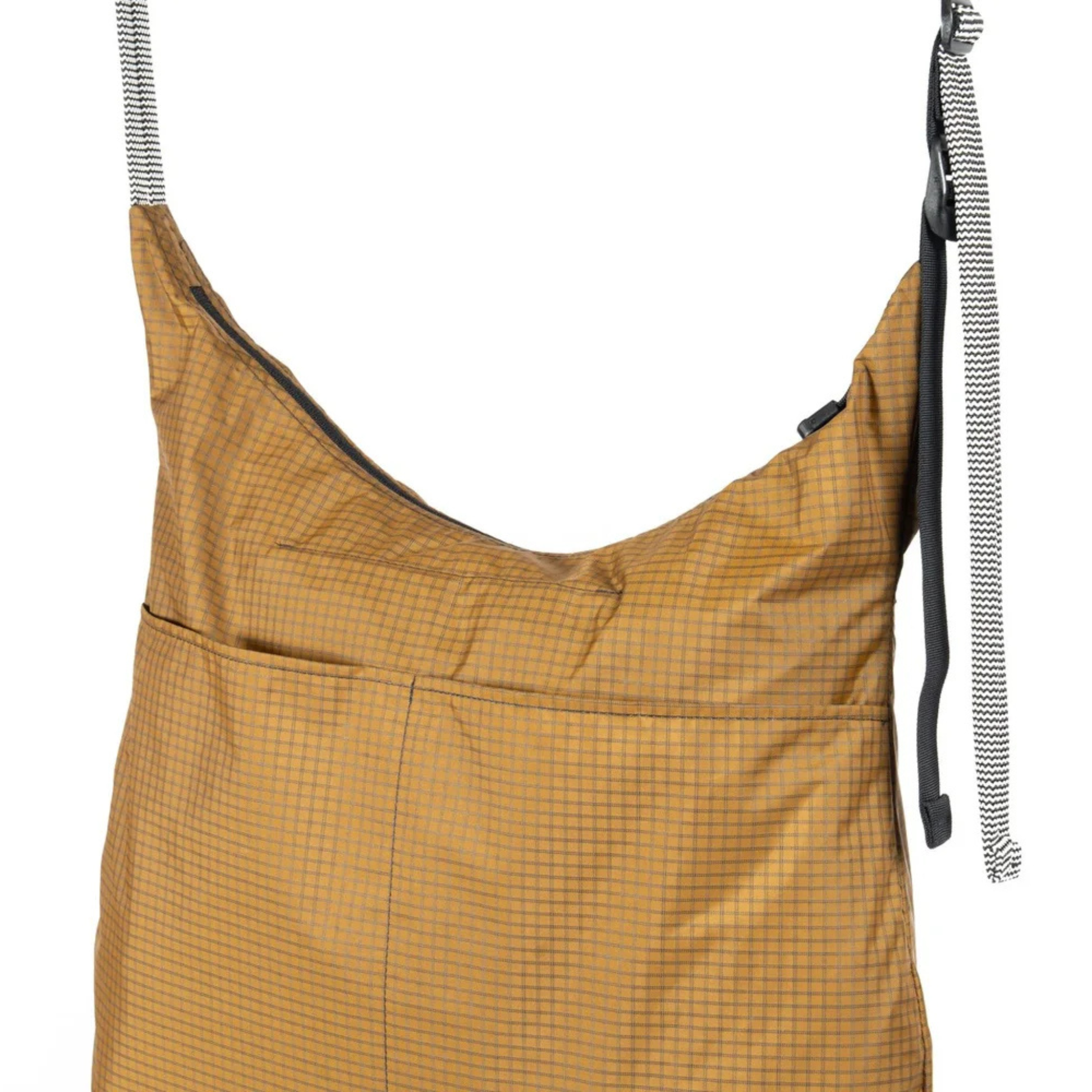 Outer Shell Magic Tote crossbody tote bag hanging from its belt