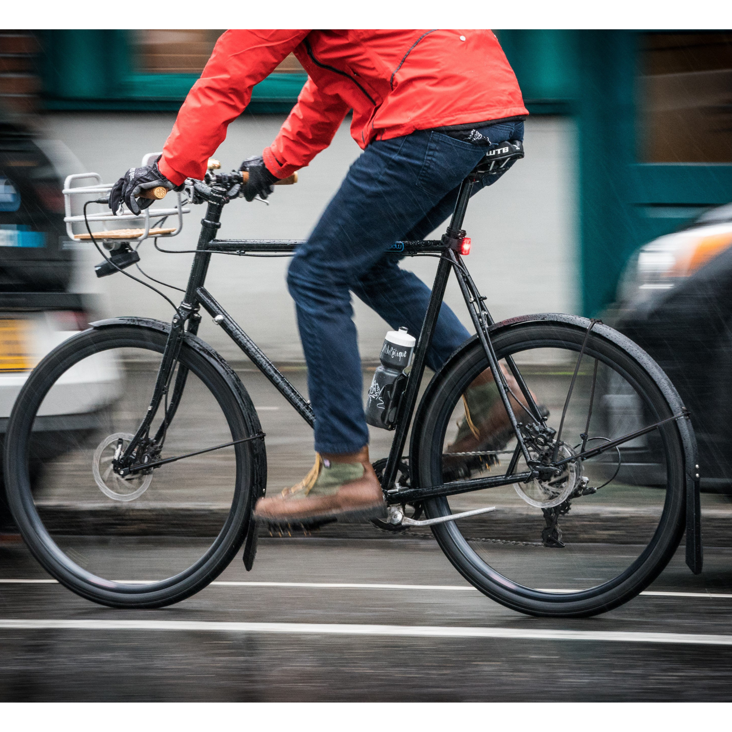 PDW Full Metal aluminum bicycle fenders installed and being ridden on a black bike in the rain