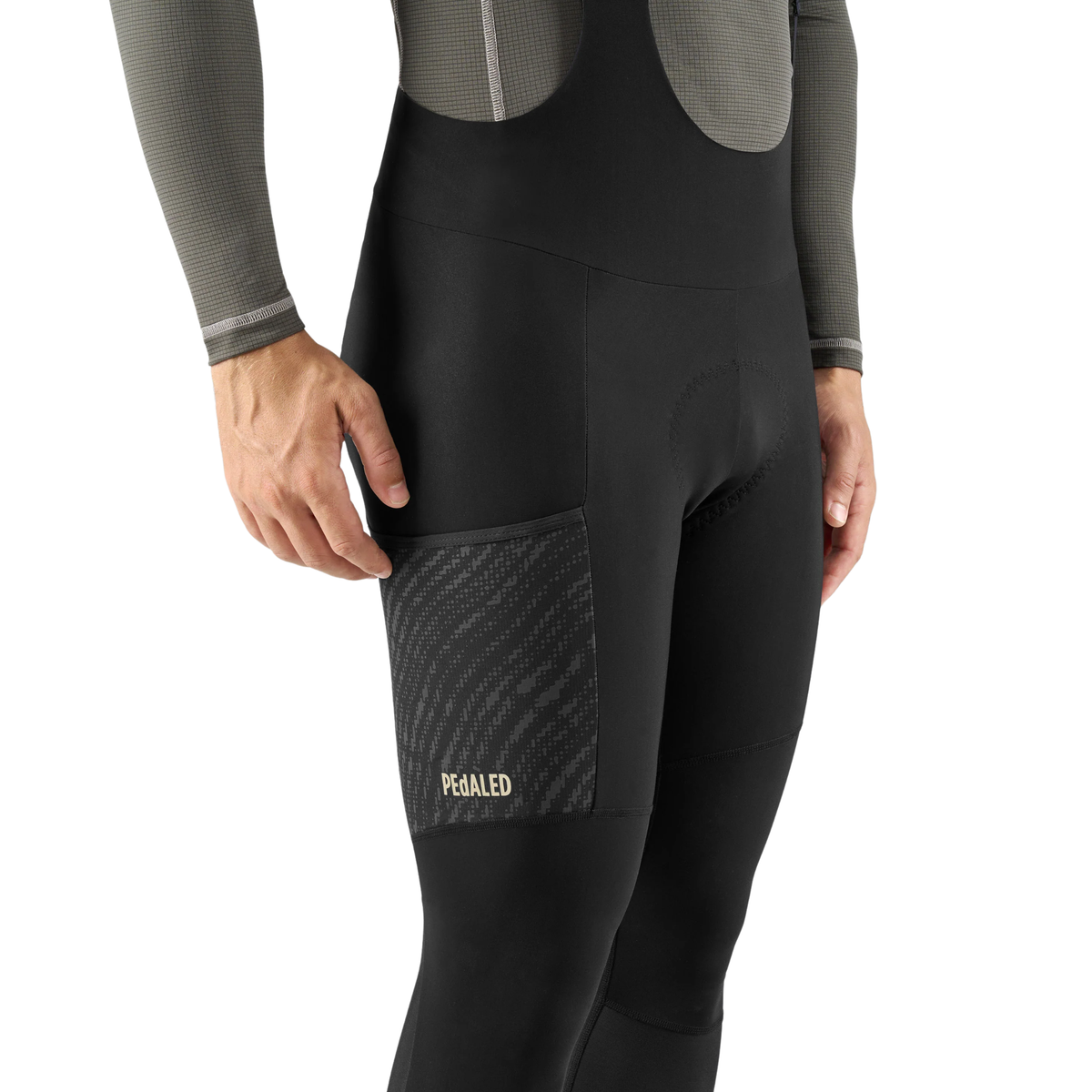 PEdALED Odyssey men's winter cycling bib tights featuring insulating fleece, weather-resistant thigh panels, three cargo pockets and reflective leg details.