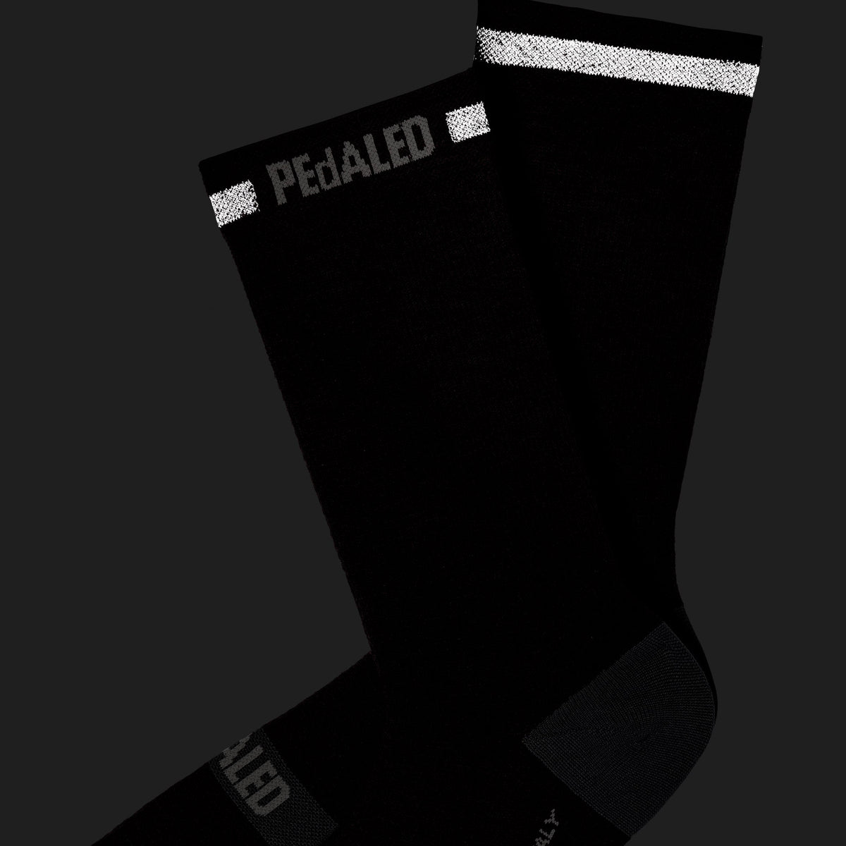 PEdALED Odyssey Merino Reflective unisex cycling socks featuring midweight wool-blend construction, light cushioning and reflective details.