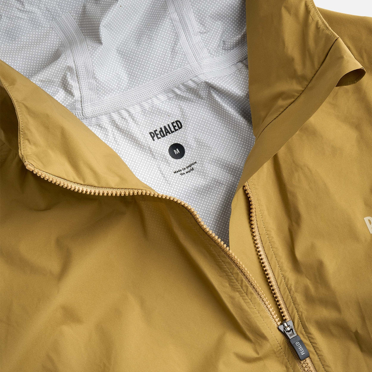 PEdALED Odyssey men's and women's waterproof cycling shell jacket featuring 2.5-layer laminated fabric, sealed seams, helmet-compatible hood and relaxed fit.