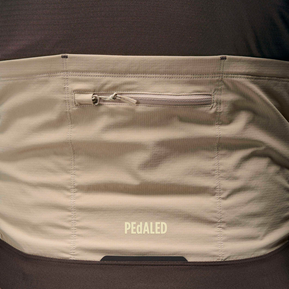 PEdALED Odyssey Windblock Merino long-sleeve men's cycling jersey with wind-blocking chest panels, seven storage pockets and reflective rear details.