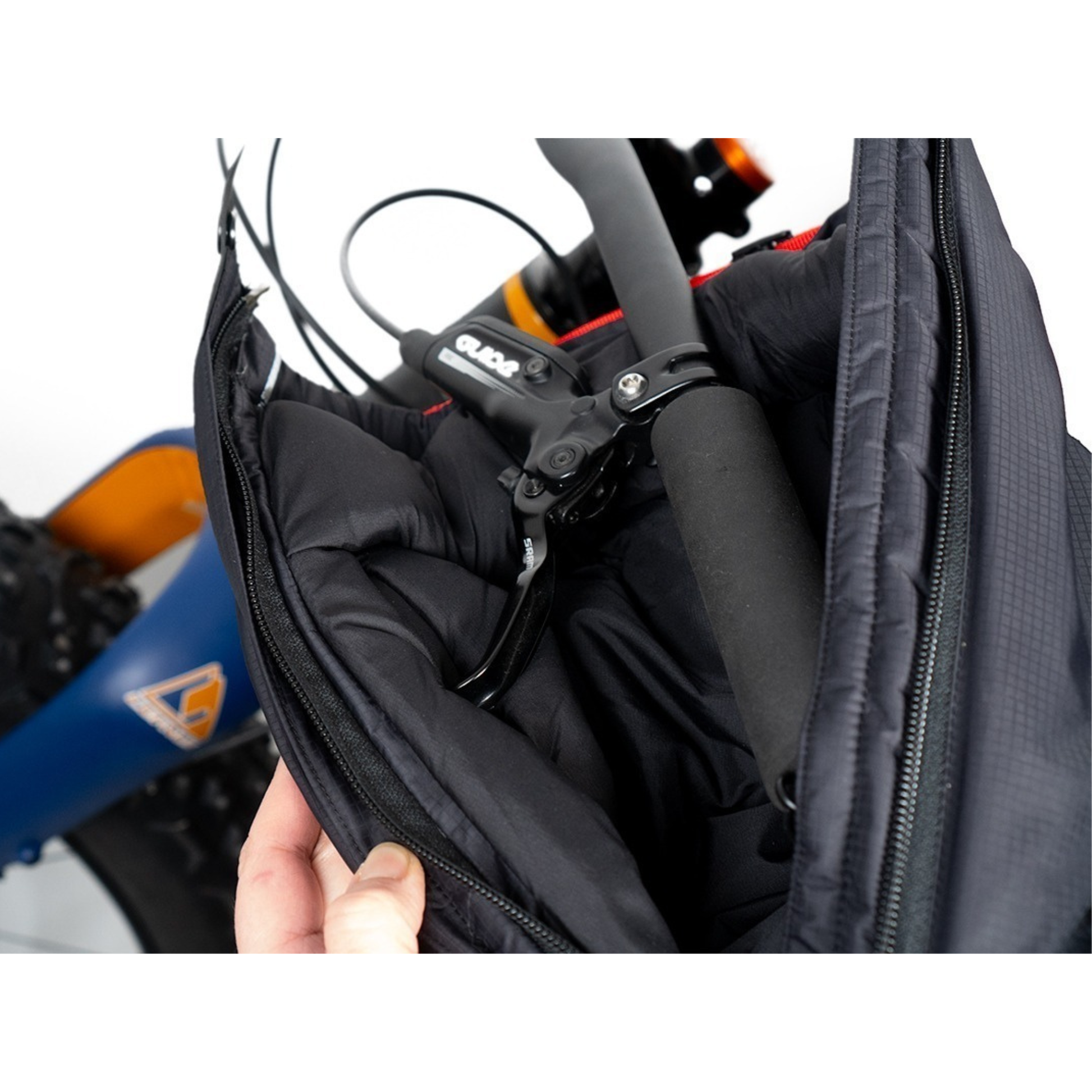 Revelate Designs Expedition Pogies insulated handlebar left pogie opened zipper, mounted on a handlebar