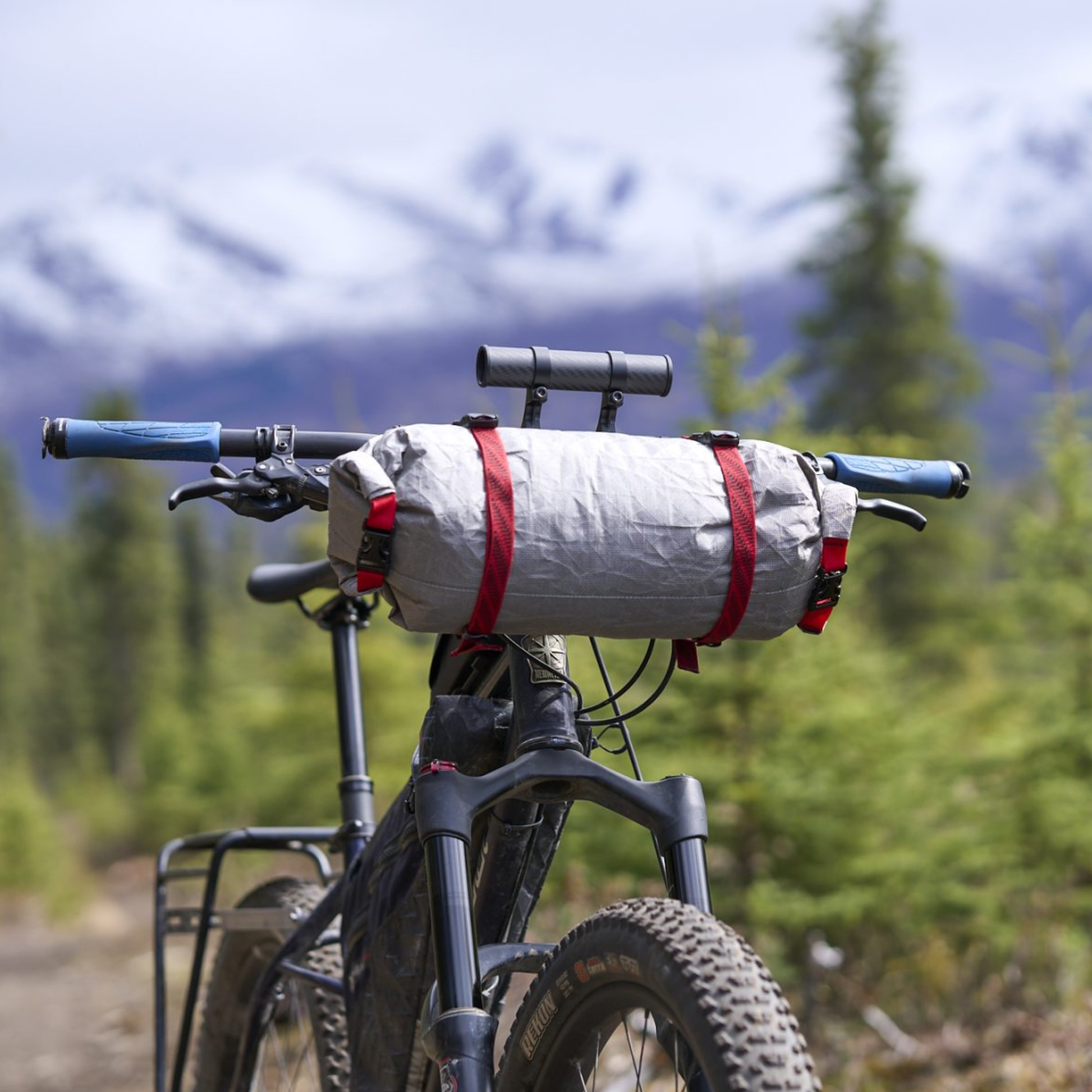 Revelate Designs Hammerhead bikepacking handlebar harness with carbon support tubes, adjustable clamps, Hypalon sling and elevated light and computer mount.