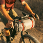 Revelate Designs Hammerhead bikepacking handlebar harness with carbon support tubes, adjustable clamps, Hypalon sling and elevated light and computer mount.