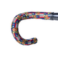 Sim Works BTP multicolored woven bicycle handlebar tape with geometric patterns wrapped around a handlebar.