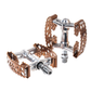 A pair of SimWorks by MKS Tiny Bubbly Bronze Edition compact platform bicycle pedals on a white background