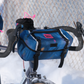 Swift Industries Luminary Catalyst Pack closed, mounted on a bicycle handlebar
