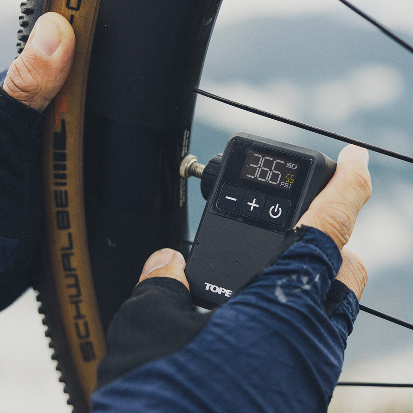 Topeak E-Booster Digital Mini electric bike pump in use with daylight