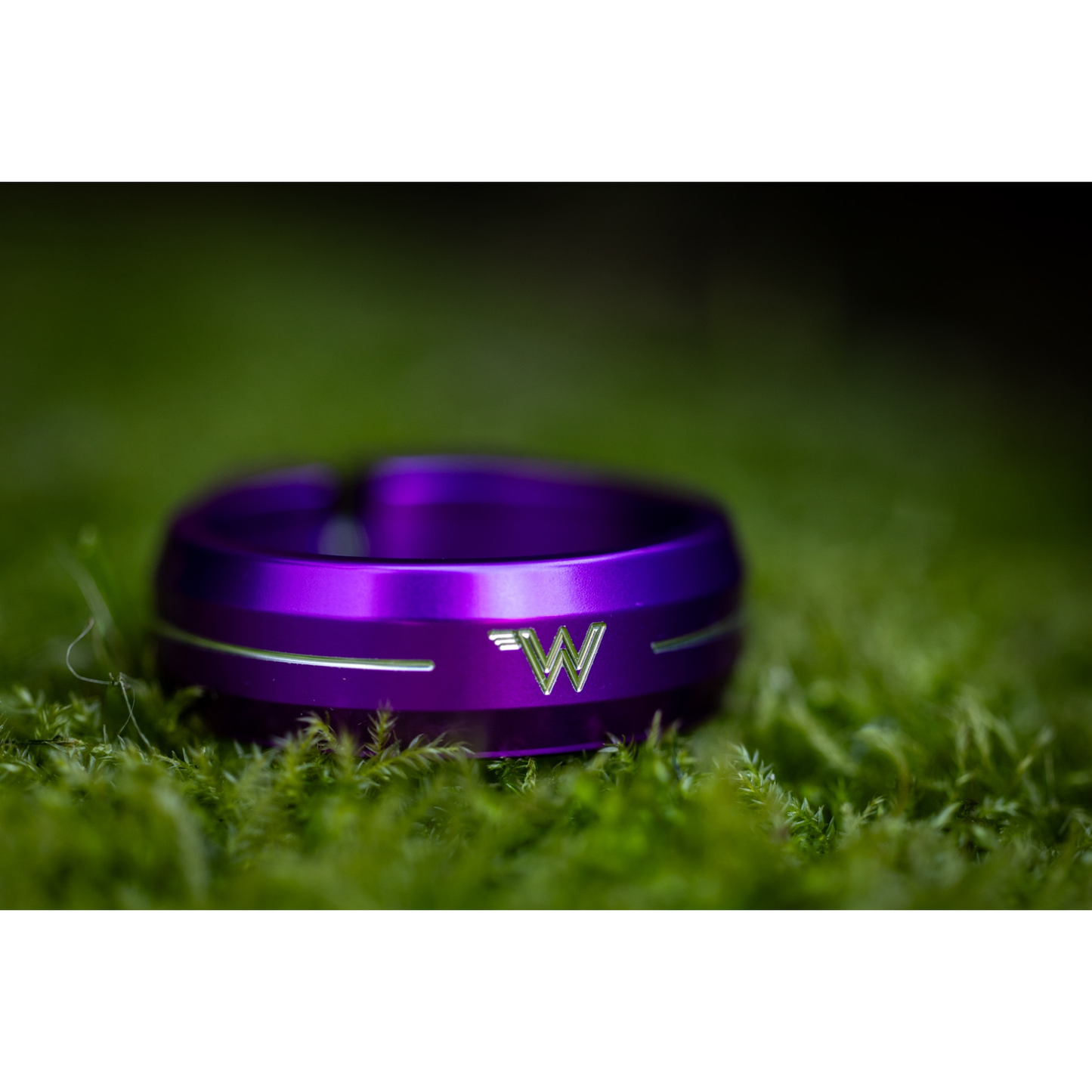 White Industries CNC-machined aluminum seat collar in purple anodized colour on green background